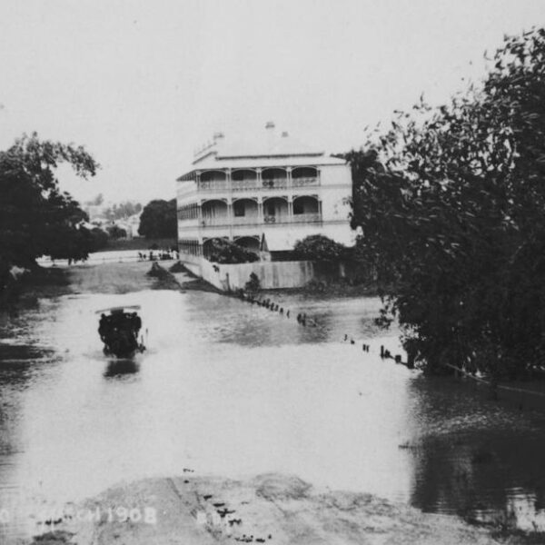 A horse and carriage driving through floodwaters around the Regatta Hotel, Toowong, March 1908.